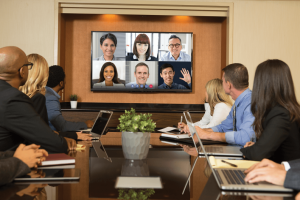 people attend a meeting in-person and virtually